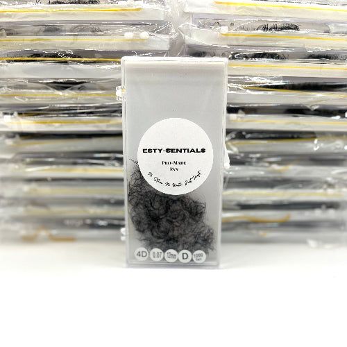 Packaged product with 'ESTY-SENTIALS' label in front of a stack of similar packages.